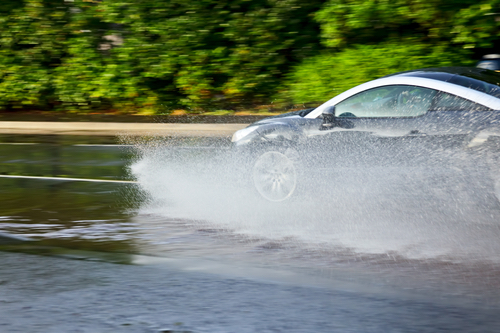 Flooded Car Driving Through Puddle