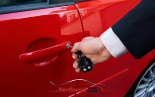 Photo of Man putting a key into a car door