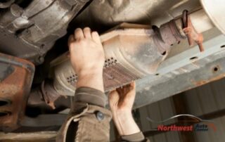 Photo of Man Removing a Catalytic Converter