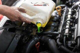 Image of mechanic pouring coolant into an engine