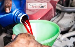 Image of Mechanic Pouring Transmission Fluid into an Engine