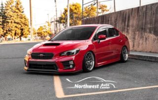 Image of Red Car in Parking Lot with Northwest Auto Center Logo